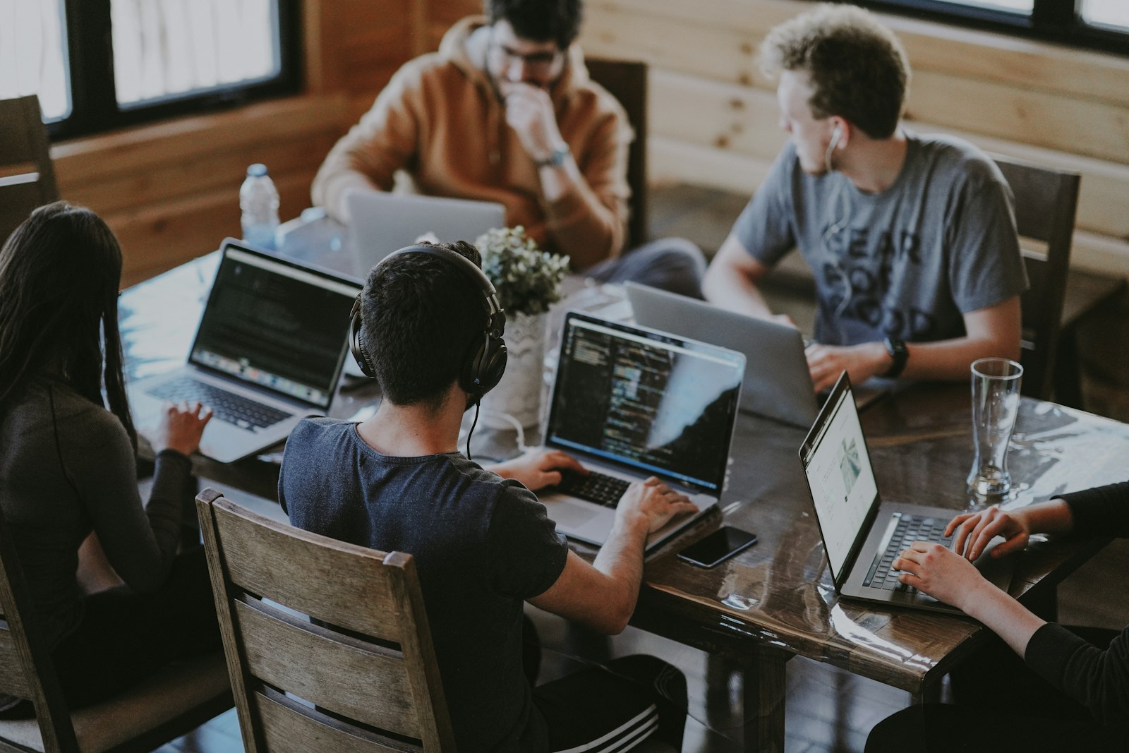 Team collaborating around laptops in a bright modern office