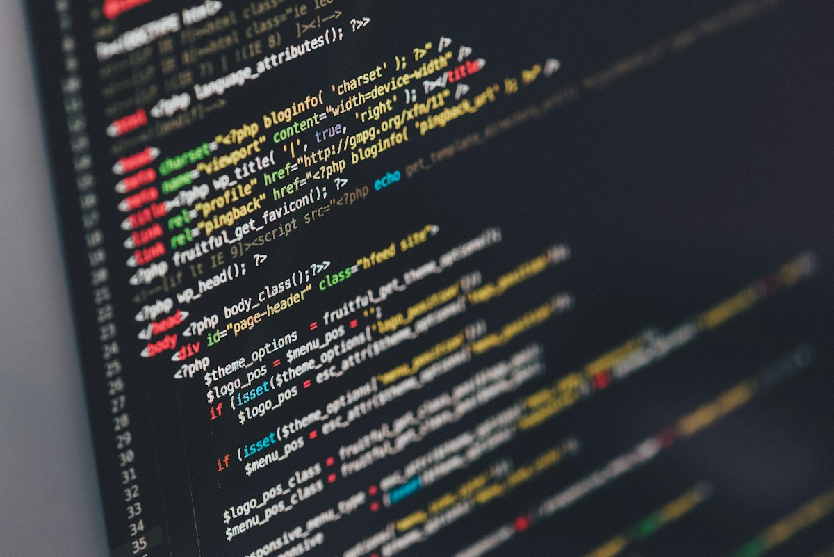 Developer writing code on a dual-monitor workstation